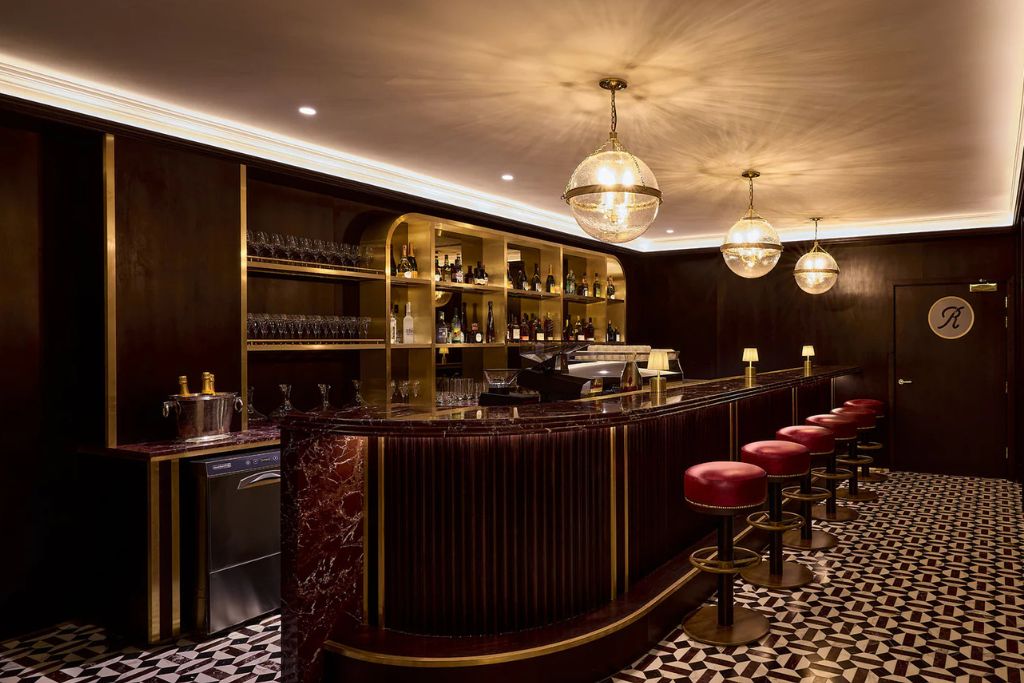 Elegant Michelin-star restaurant interior with marble bar, warm lighting and luxury dining atmosphere.