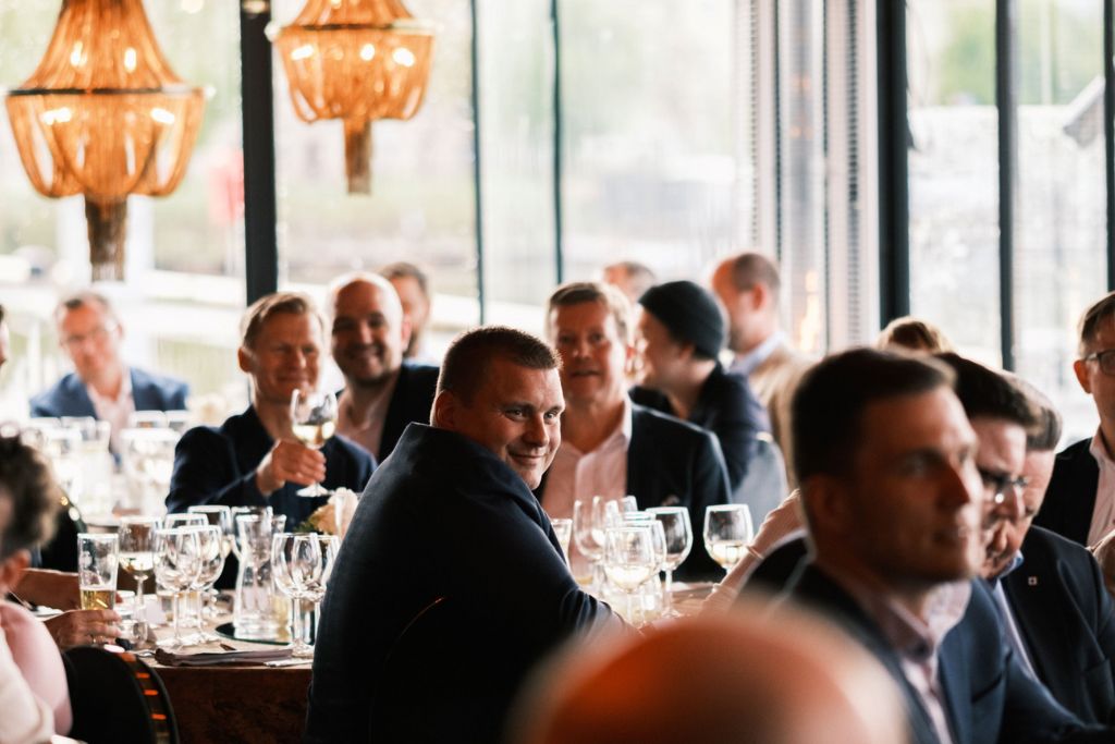 Business dinner networking event with professionals gathered around a restaurant table.