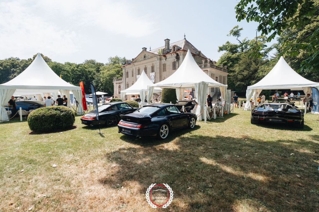 Luxury sports cars displayed at the Geneva Supercar Show in front of an elegant European estate surrounded by exhibition tents.