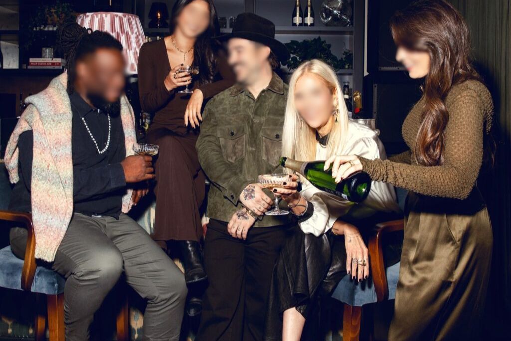 Colleagues enjoying drinks and conversations during an elegant company party and after-work gathering.
