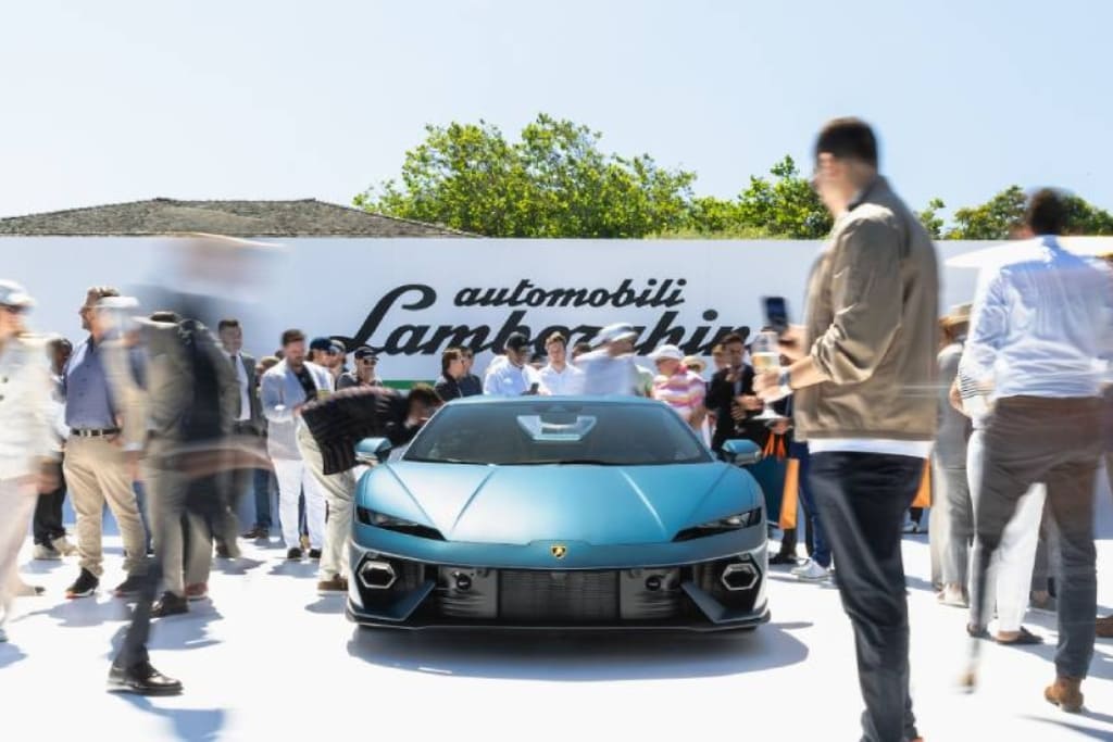 Luxury car launch event with attendees gathered around a newly unveiled Lamborghini at an outdoor brand presentation.