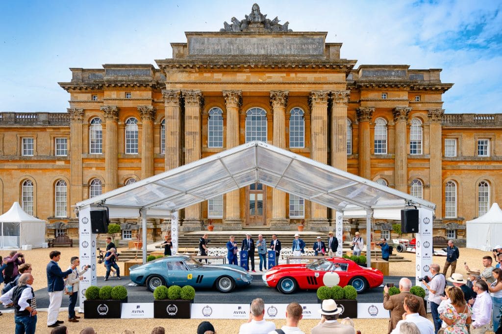 Classic luxury cars displayed at Salon Privé UK in front of a historic British estate with spectators attending the concours event.