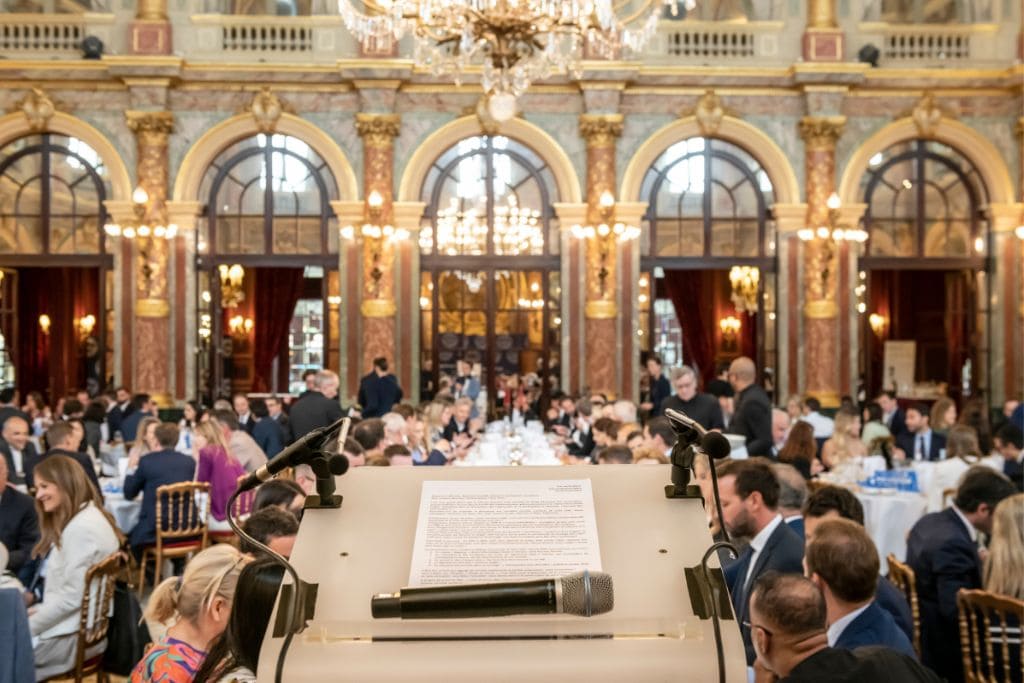 Formal dinner event at the Chinese Business Club in Paris with executives networking inside an ornate ballroom.