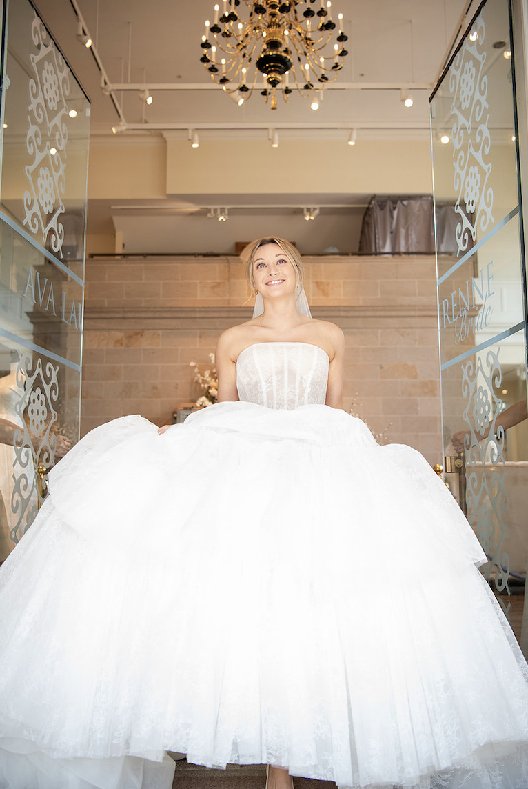 Bride viewing wedding dresses with stylist at a bridal shop in Fredericksburg Virginia