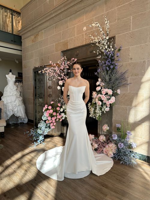 Modern fit and flare bridal gown with floral appliqué in Fredericksburg Virginia bridal boutique