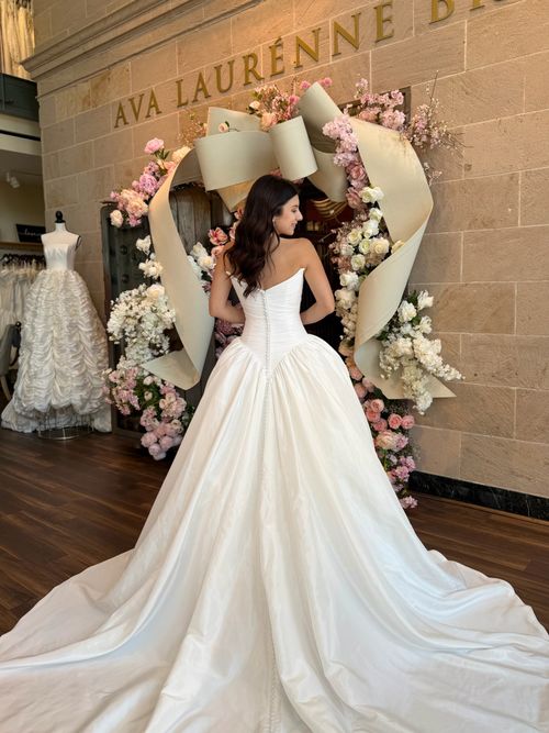 Satin ball gown wedding dress with dramatic train at Ava Laurénne Bride Fredericksburg bridal shop