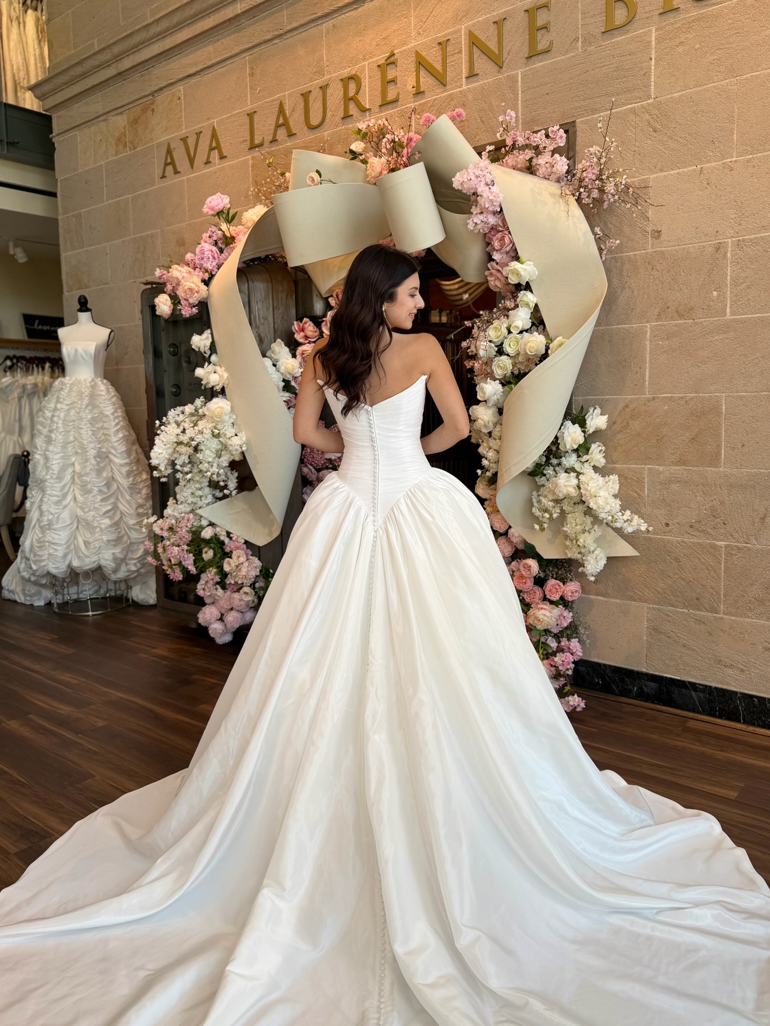Satin ball gown wedding dress with dramatic train at Ava Laurénne Bride Fredericksburg bridal shop