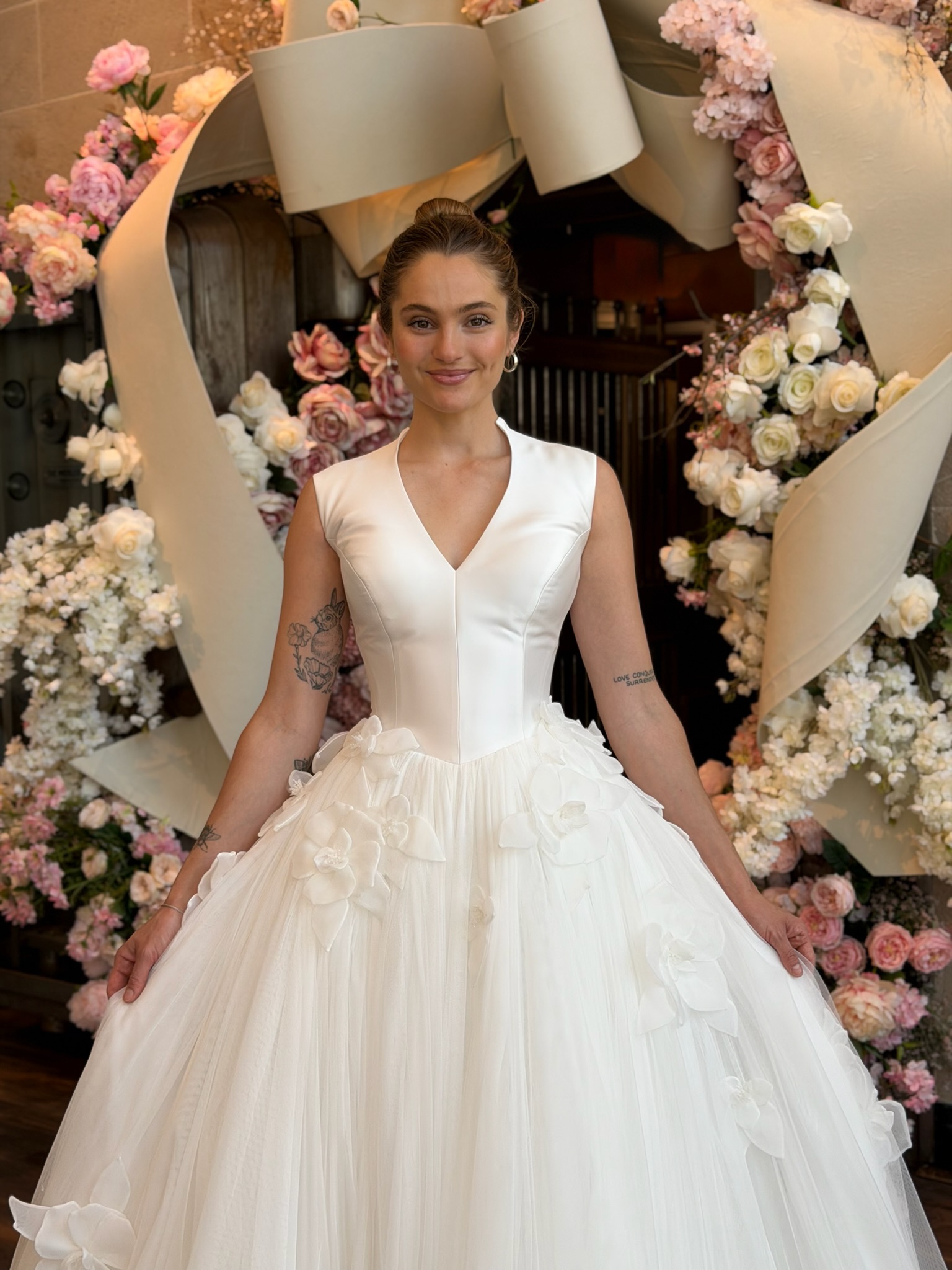 Minimalist satin ball gown wedding dress with floral appliqué at Ava Laurénne Bride