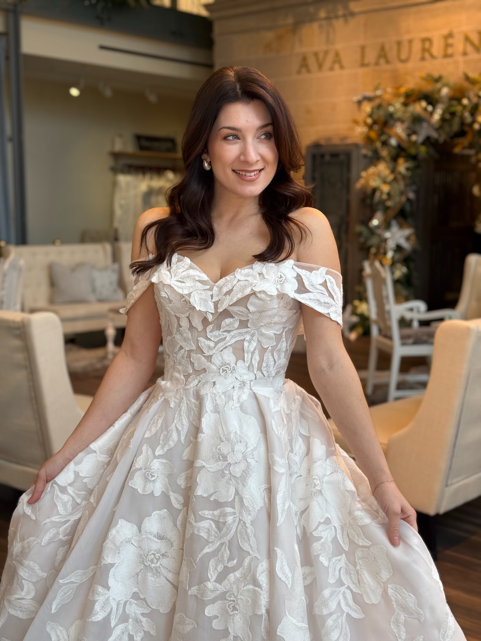 Statement off the shoulder wedding gown with dramatic volume and luxurious lace embellishments