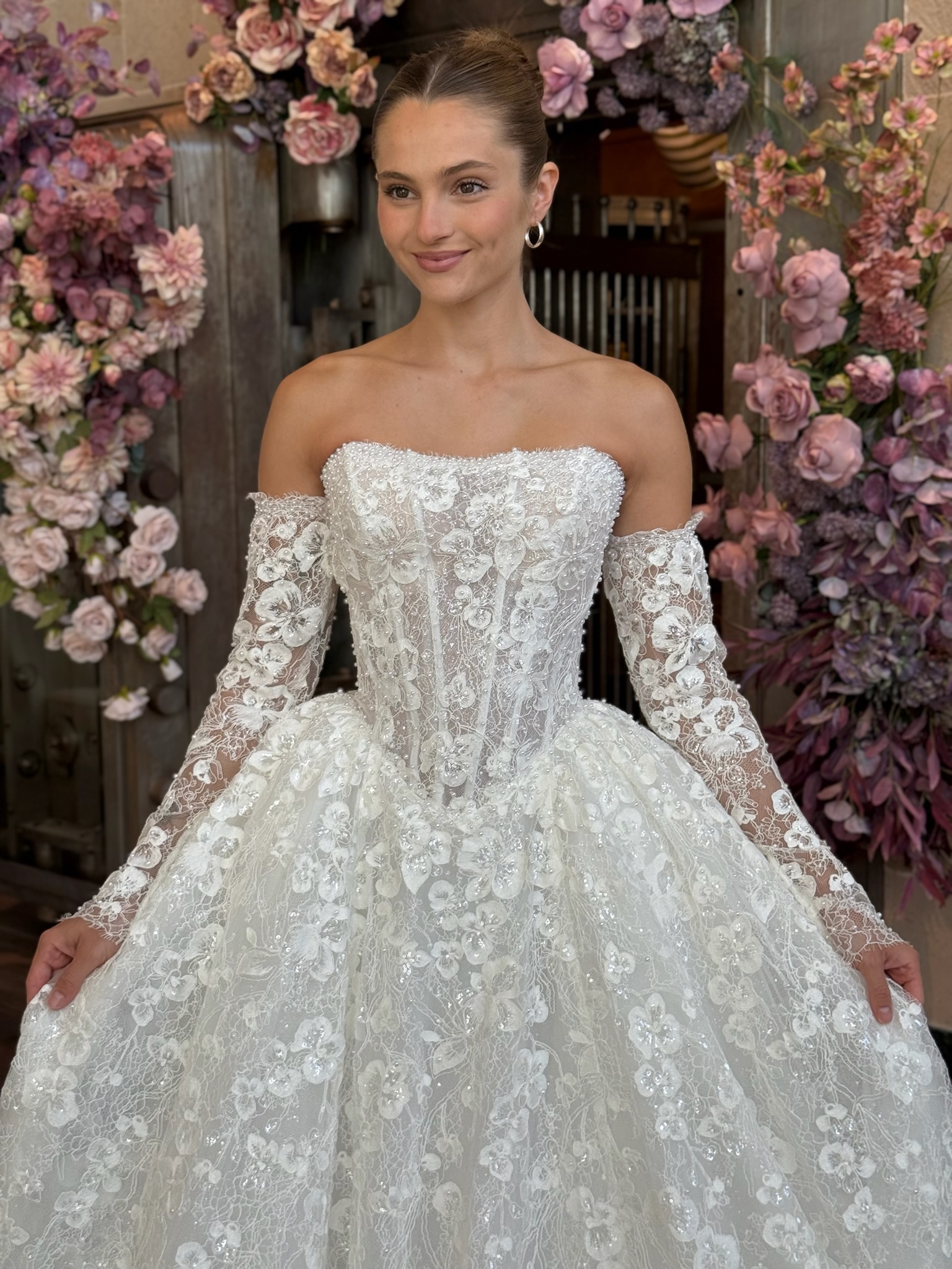 Bride in an off the shoulder lace wedding dress with corset bodice and soft tulle skirt