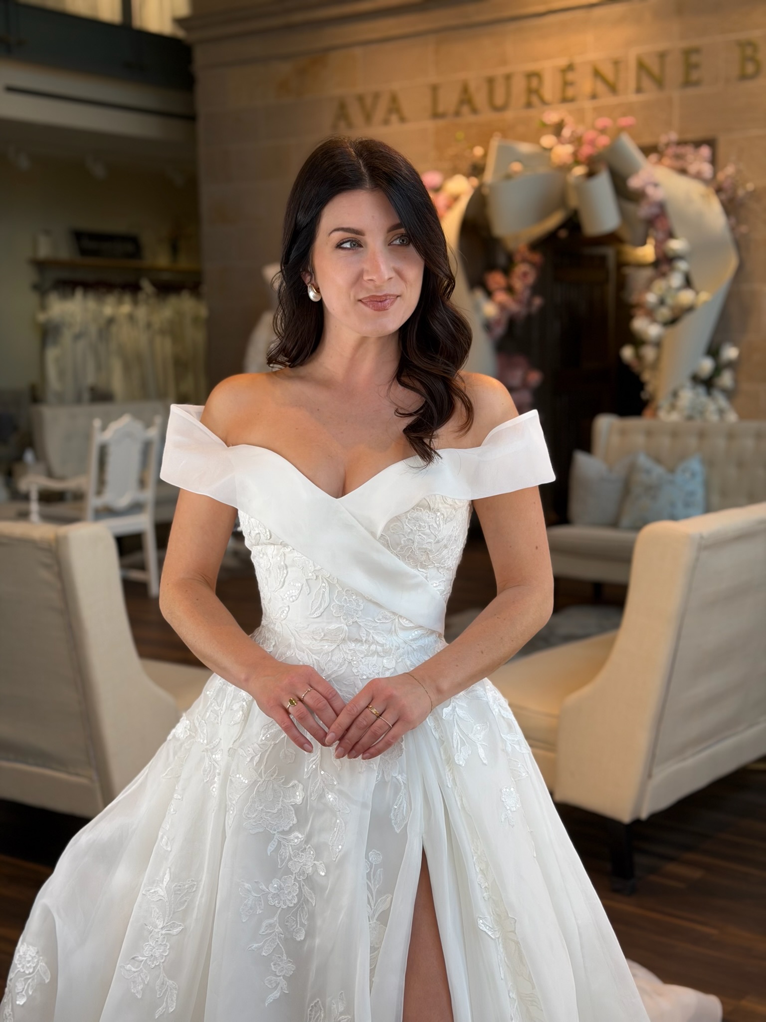 Statement off the shoulder wedding gown with dramatic volume and luxurious lace embellishments