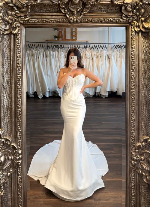 Statement off the shoulder wedding gown with dramatic volume and luxurious lace embellishments
