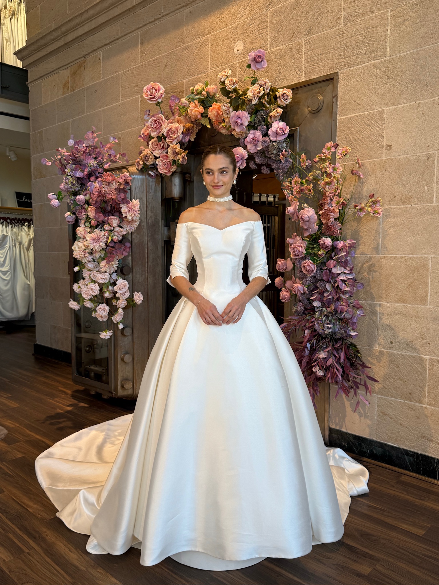 Statement off the shoulder wedding gown with dramatic volume and luxurious lace embellishments