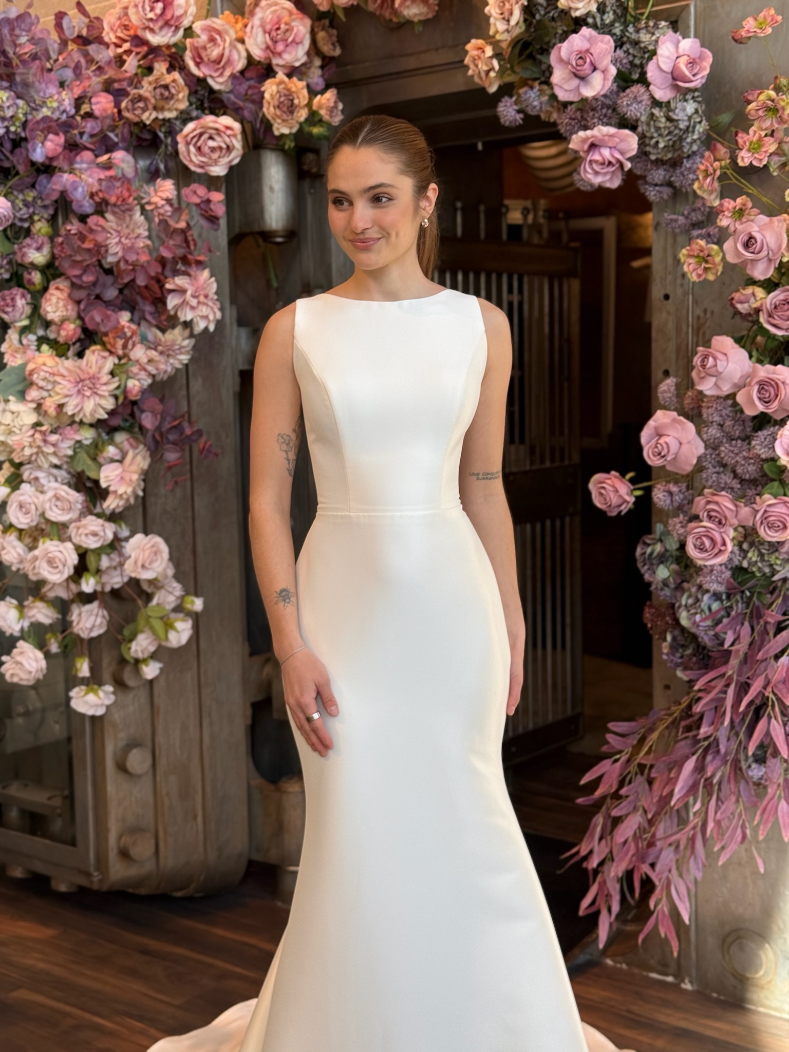 Modern high neckline wedding dress with fitted silhouette at luxury bridal boutique in Fredericksburg VA