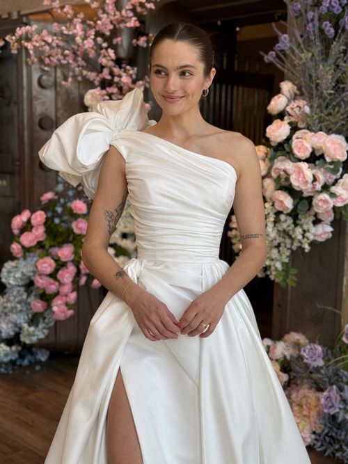 High neckline wedding gown featuring intricate floral lace and romantic bridal styling