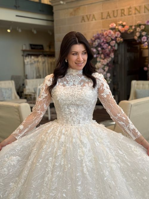 Long sleeve high neckline bridal gown with illusion lace detailing at Ava Laurénne Bride