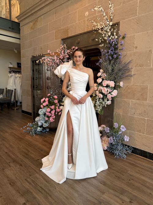 High neckline wedding gown featuring intricate floral lace and romantic bridal styling