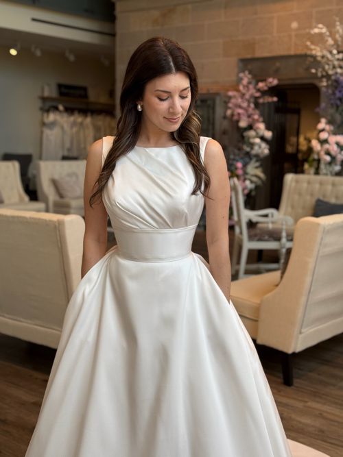 Elegant bridal gown with high neckline and long lace sleeves at Ava Laurénne Bride