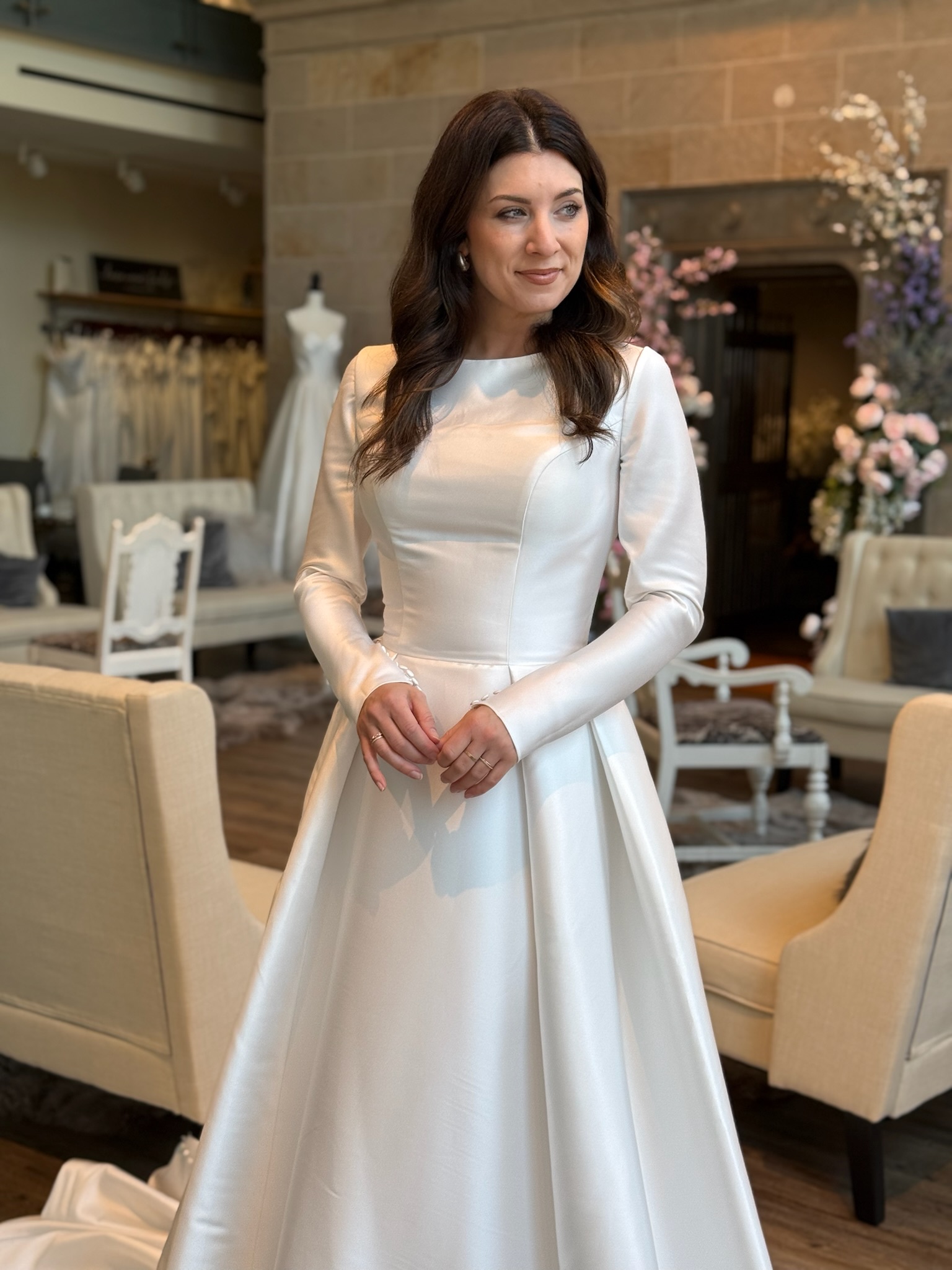Elegant bridal gown with high neckline and long lace sleeves at Ava Laurénne Bride