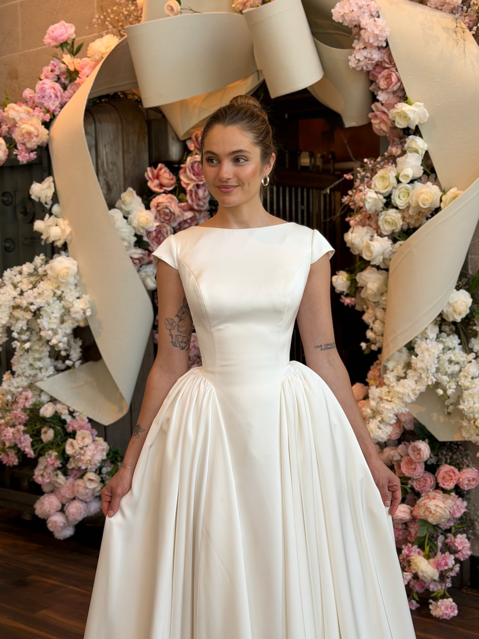 Bride wearing a fitted high neckline wedding dress with sheer illusion details in Virginia bridal shop