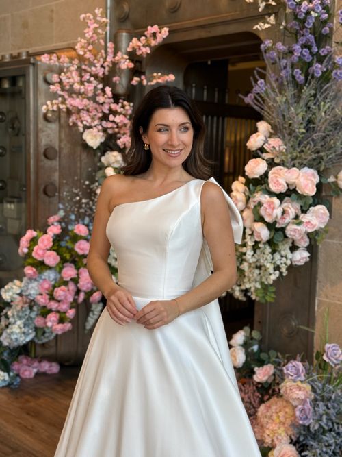 Elegant bridal gown with high neckline and long lace sleeves at Ava Laurénne Bride