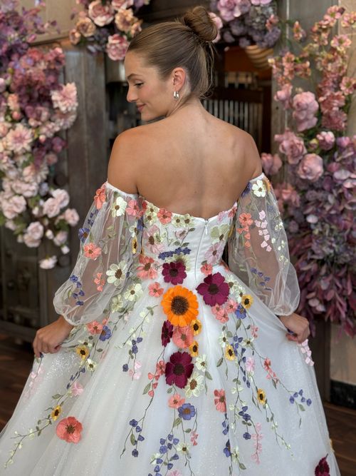 Colorful bridal ball gown with floral embroidery displayed at Ava Laurènne Bride