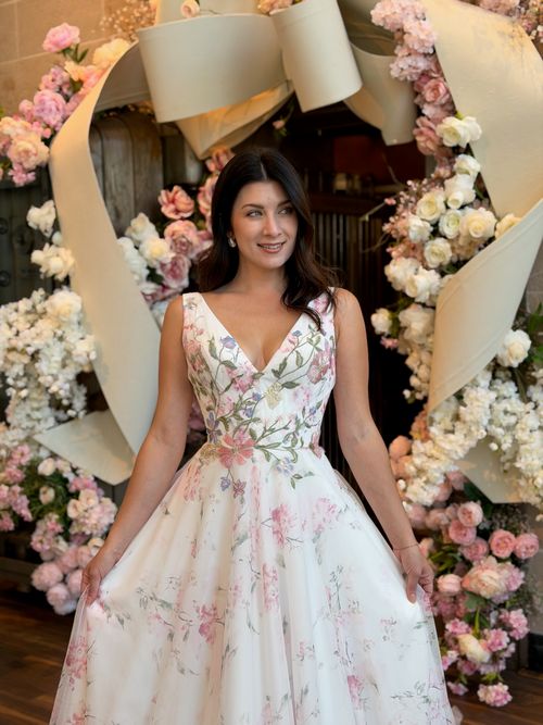 Colorful bridal ball gown with floral embroidery displayed at Ava Laurènne Bride