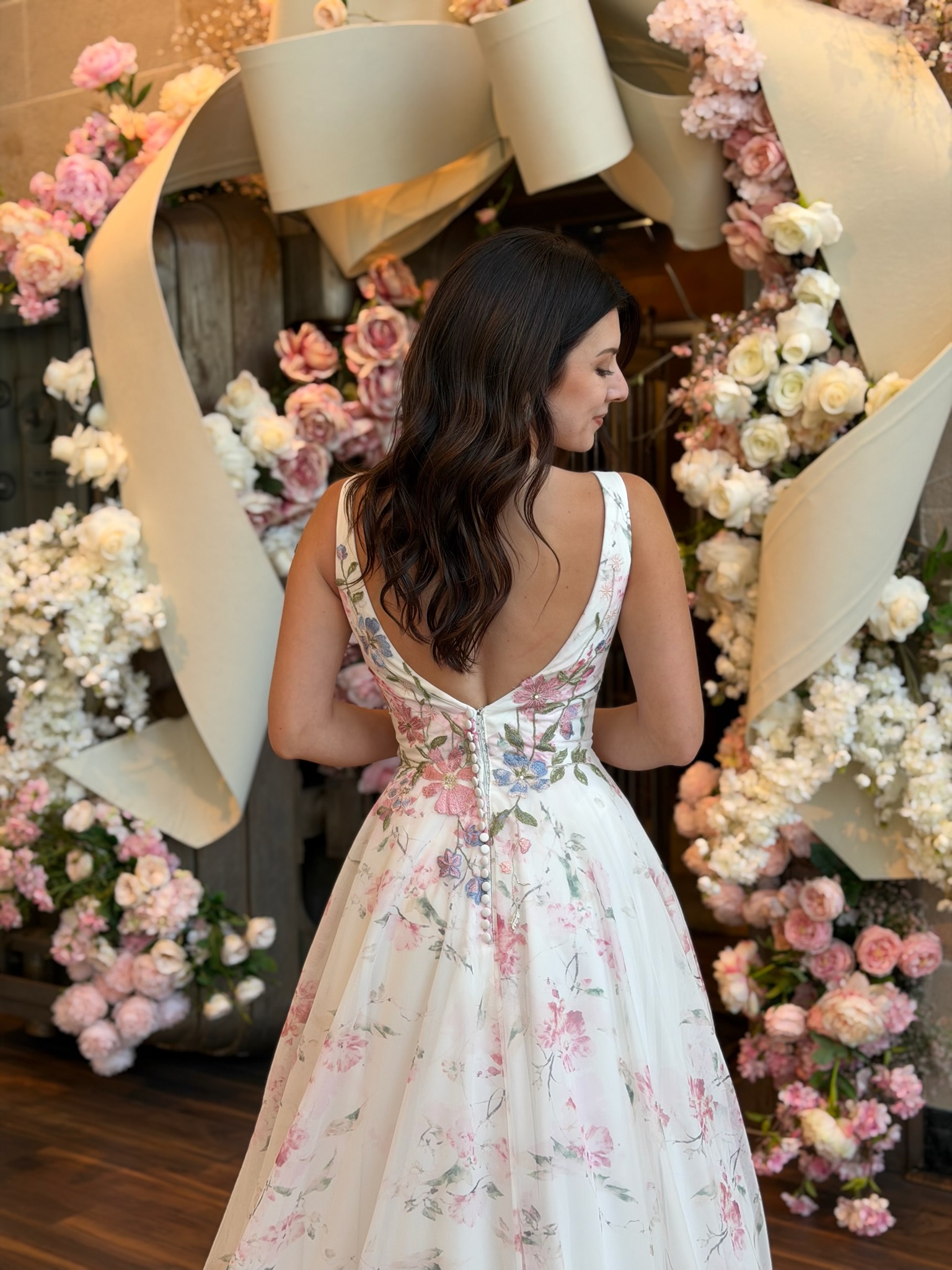 Colorful bridal ball gown with floral embroidery displayed at Ava Laurènne Bride