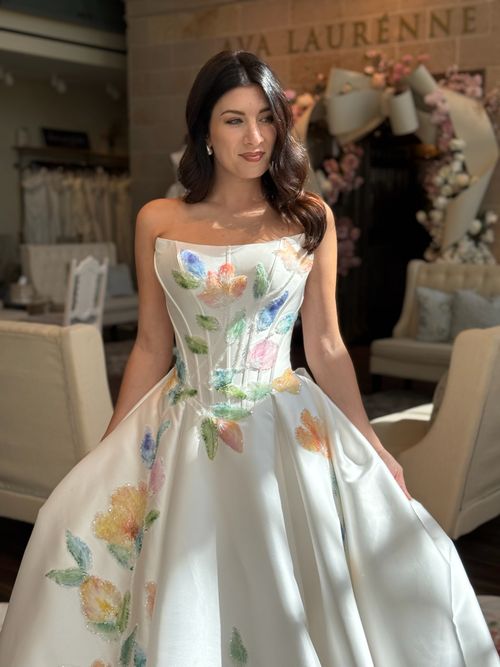Colorful bridal ball gown with floral embroidery displayed at Ava Laurènne Bride