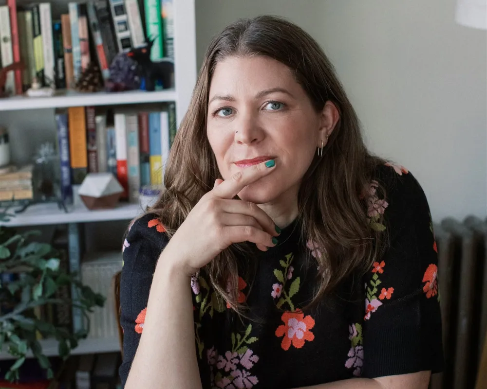 Jen Mayer, AFC® portrait wearing a black sweater.