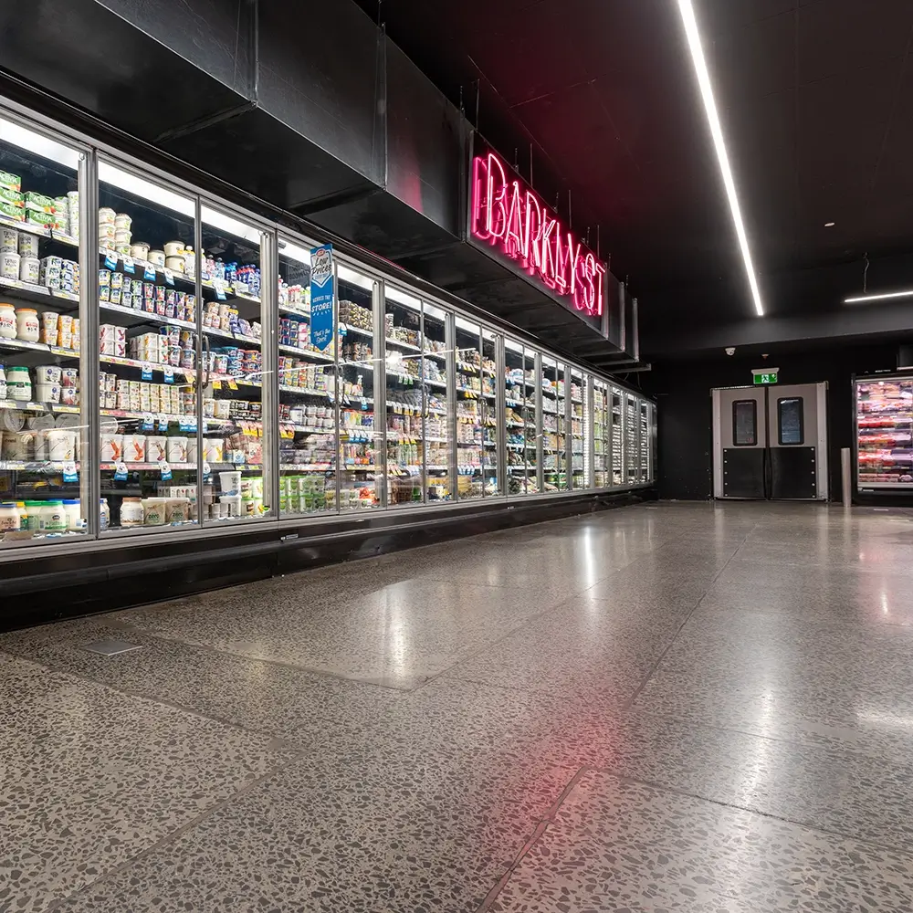 Polished concrete supermarket flooring in front of freezer section under Barkly Street signage.
