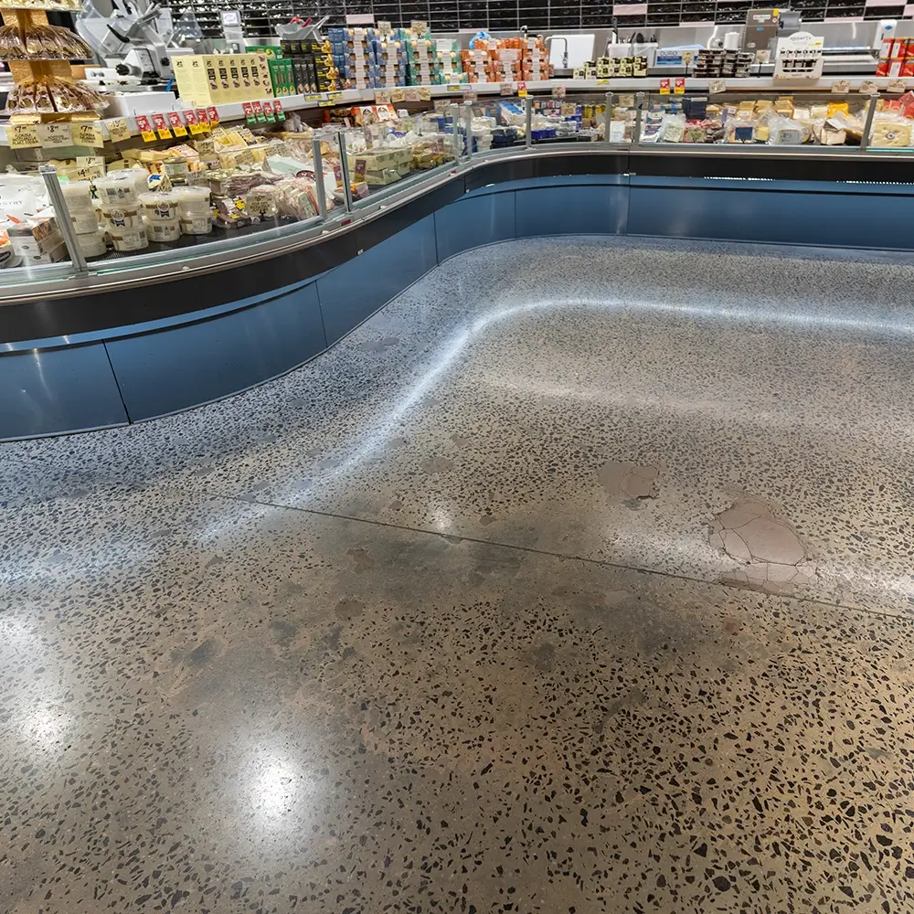 Seamless polished concrete floor in supermarket deli area with hygienic, easy-clean finish.