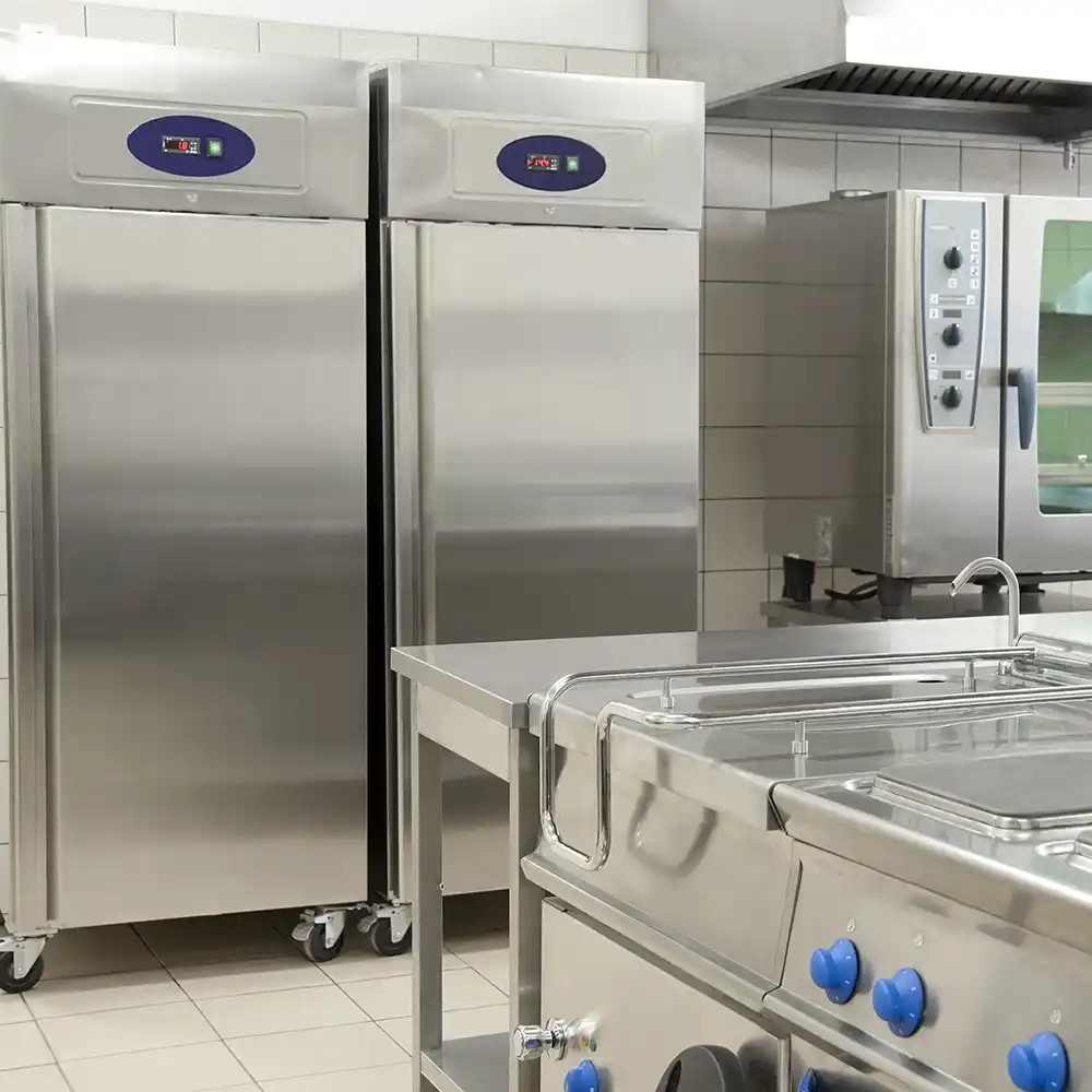 Close-up of a coolroom kitchen featuring stainless steel appliances and seamless hygienic flooring.