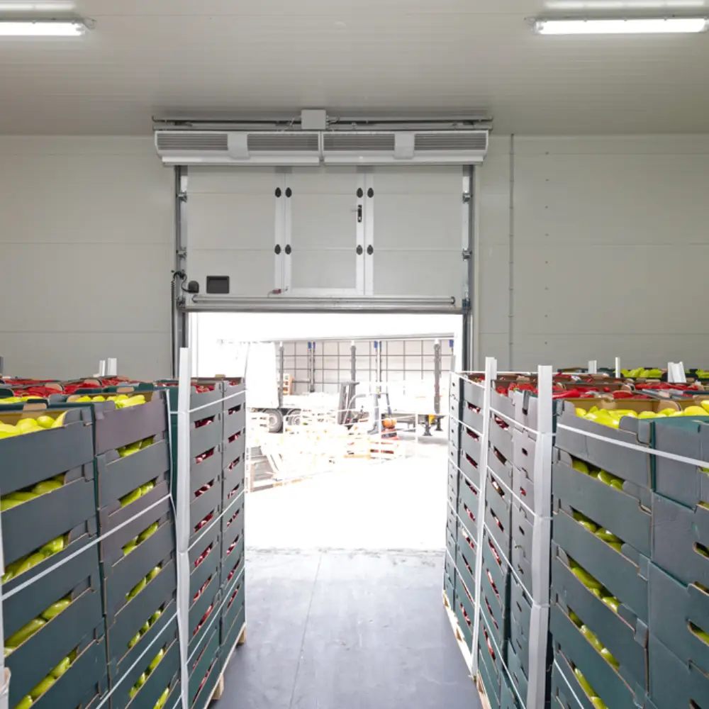 Wide-angle view of a commercial stainless steel kitchen with durable non-slip tiled flooring.
