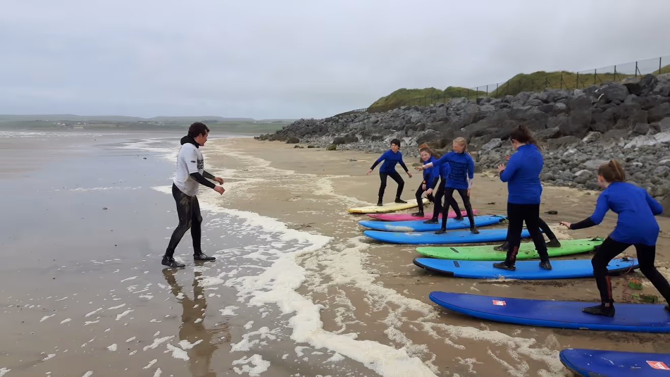 Ollie's Surf School on Lahinch beach men and women learning to surf