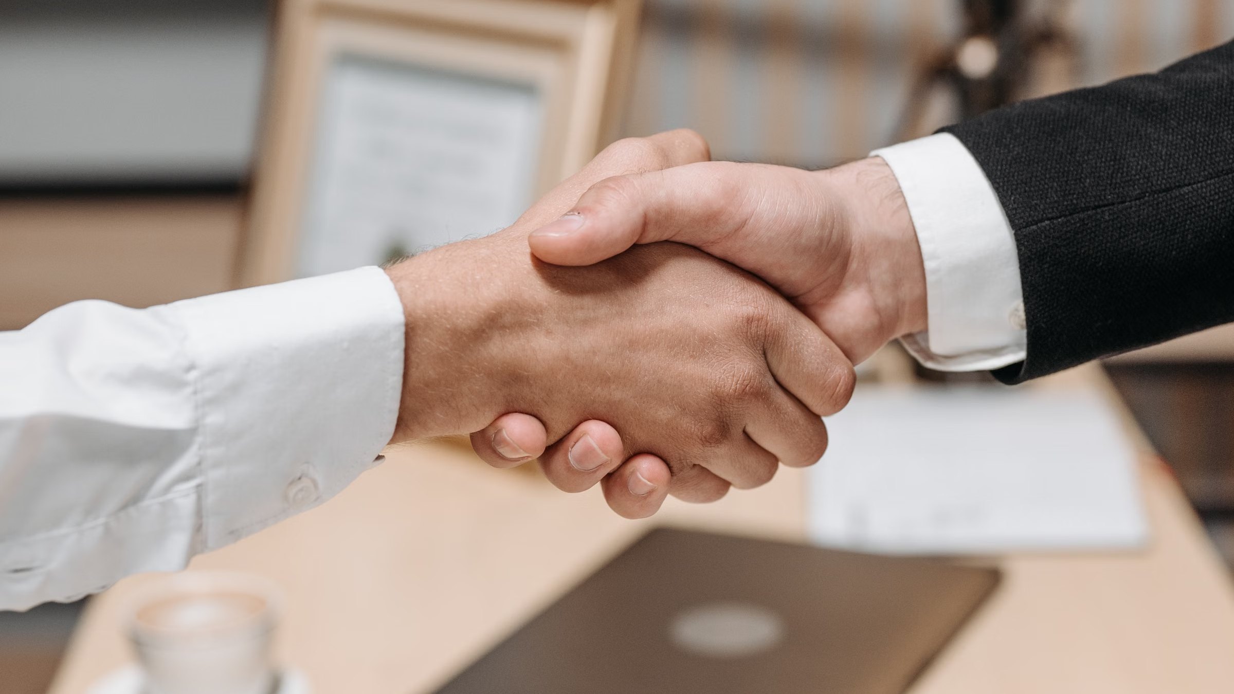 Two people shaking hands in an office