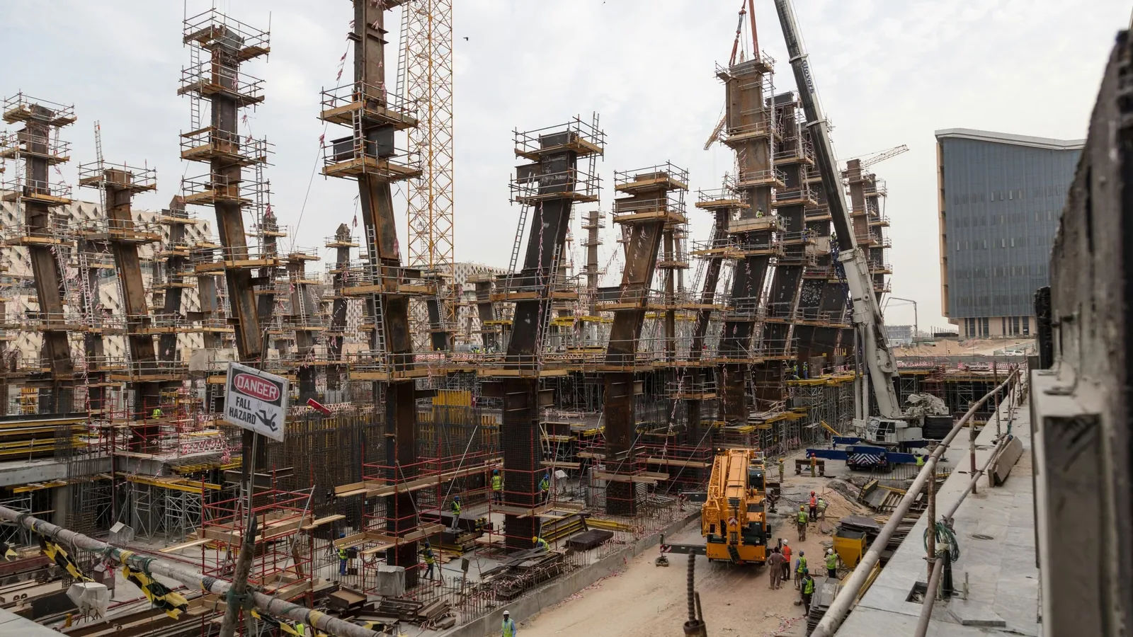 An active construction site where AI-powered cameras monitor PPE compliance and site access