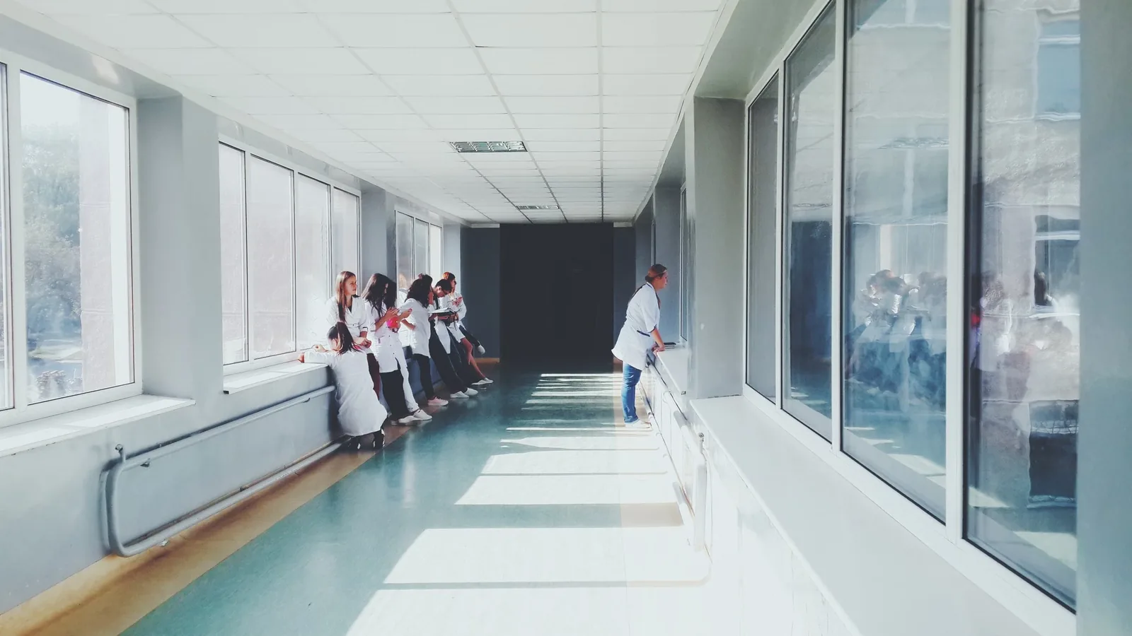 Clinical staff in a bright hospital corridor