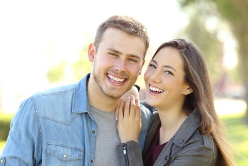 happy patient holding a water cup given by dentist