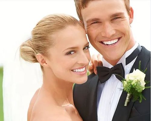 happy patient holding a water cup given by dentist