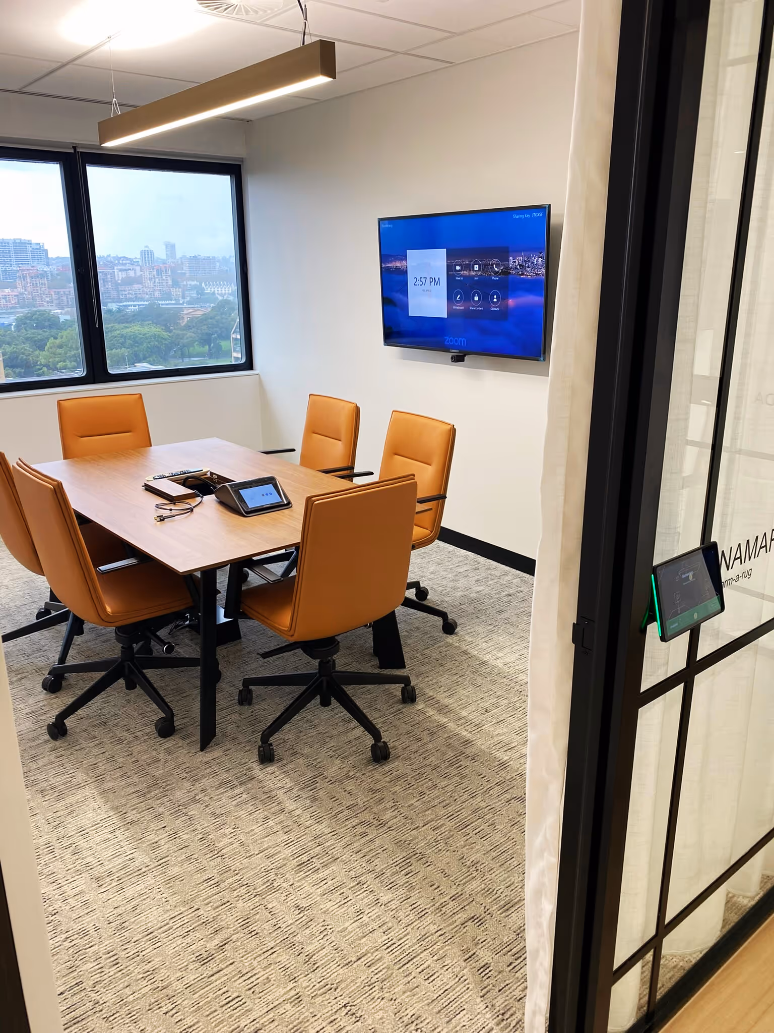 Medium Zoom Room utilising Crestron Flex and Huddly hardware with a Neat Pad scheduling display