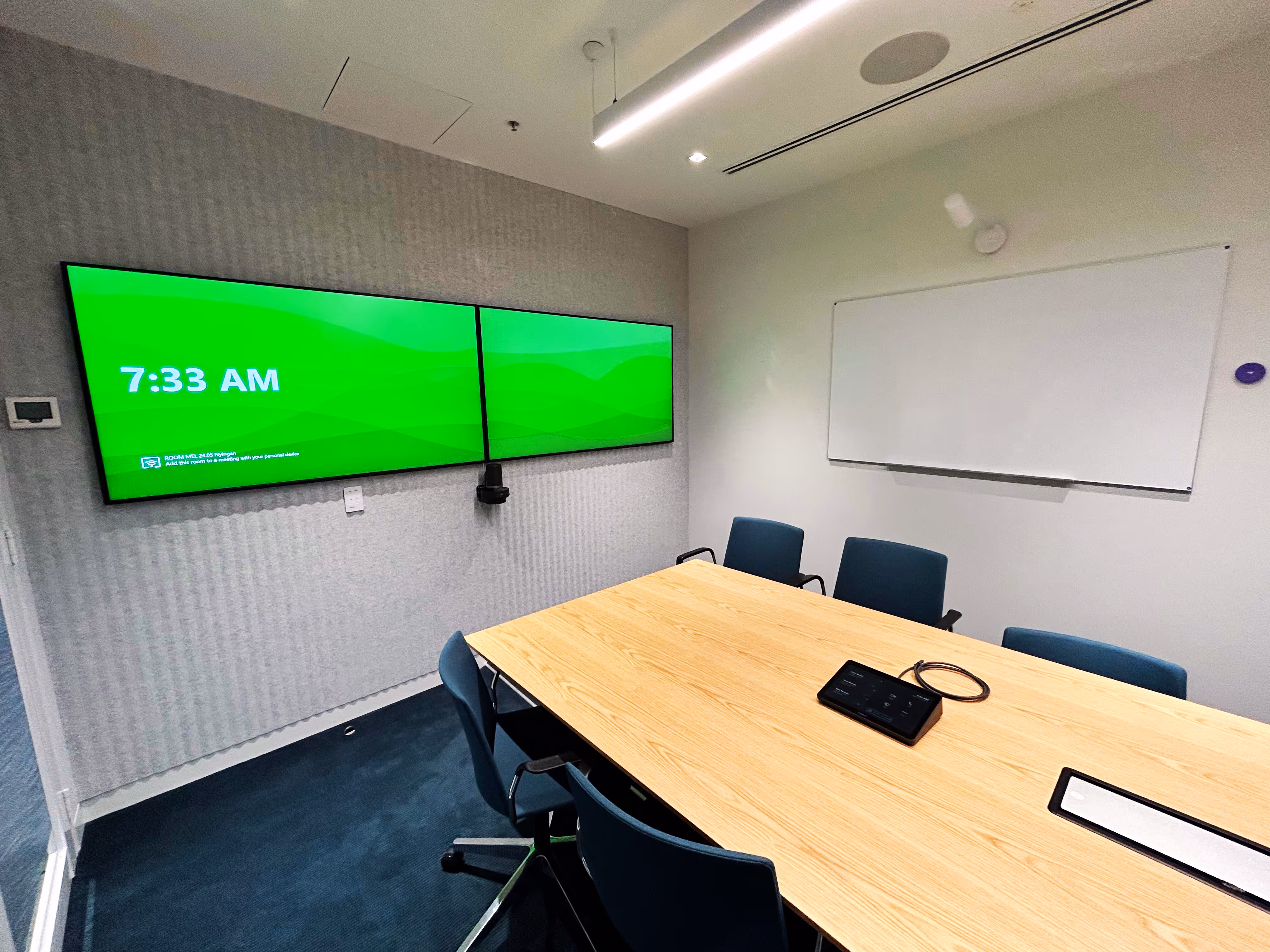 Large dual screen Microsoft Teams Room utilising Logitech hardware including Scribe whiteboard camera and biamp audio system