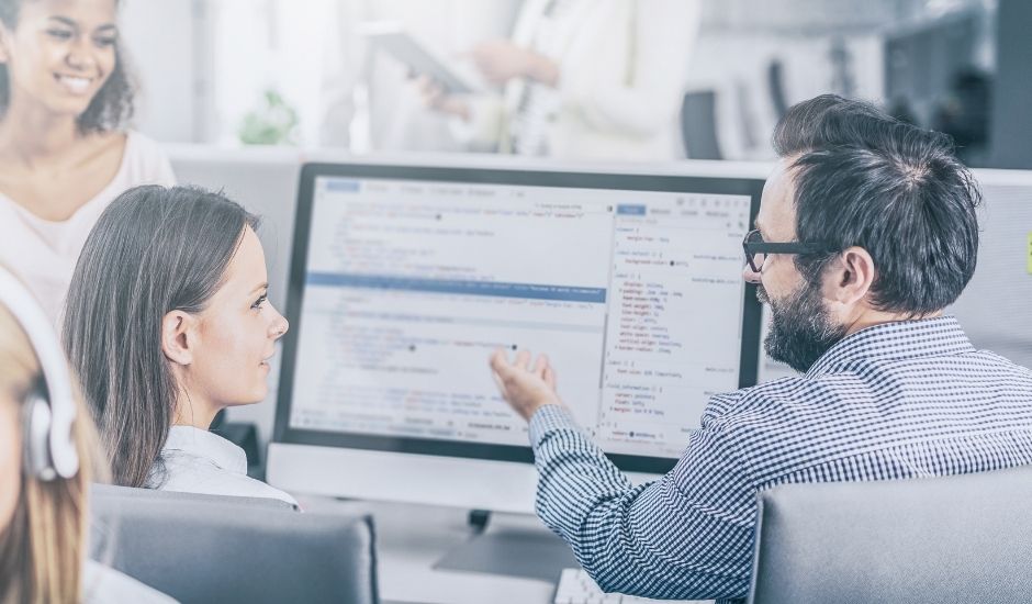 IT Manager helping another employee with some code