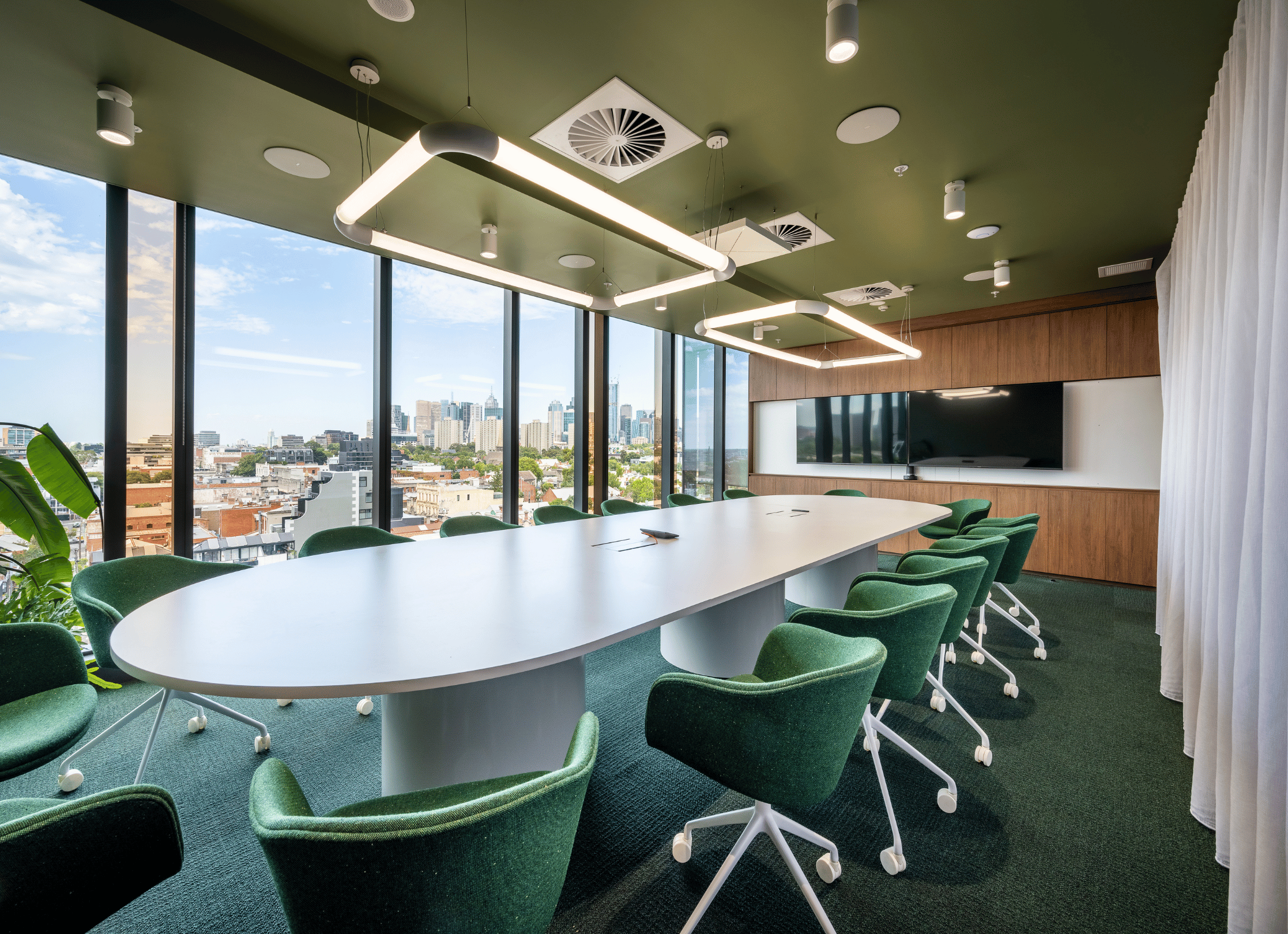 A large Microsoft Teams Boardroom equipped with a Logitech system and Sennheiser TeamConnect ceiling mics