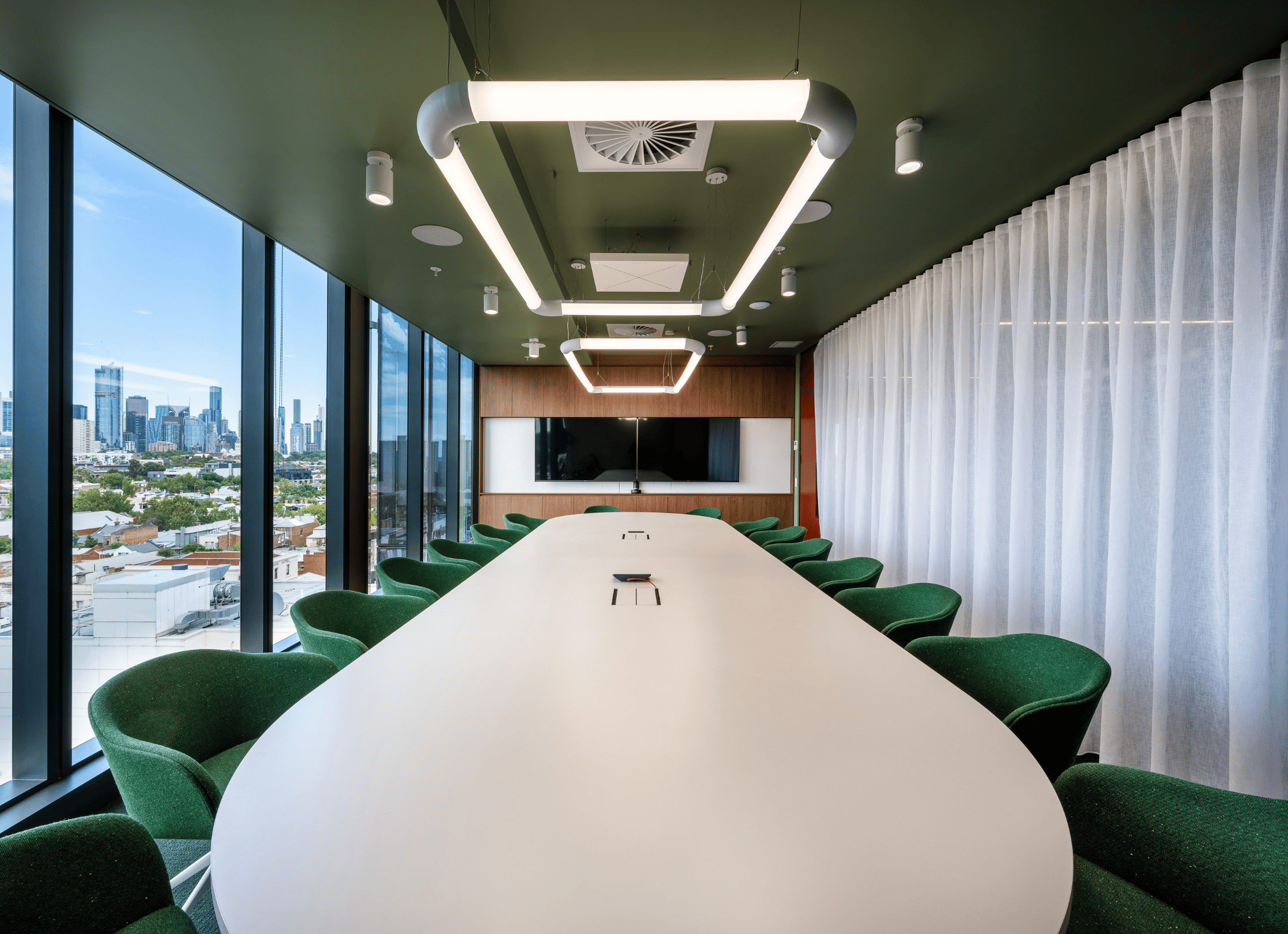 A large Microsoft Teams Boardroom equipped with a Logitech system and Sennheiser TeamConnect ceiling mics