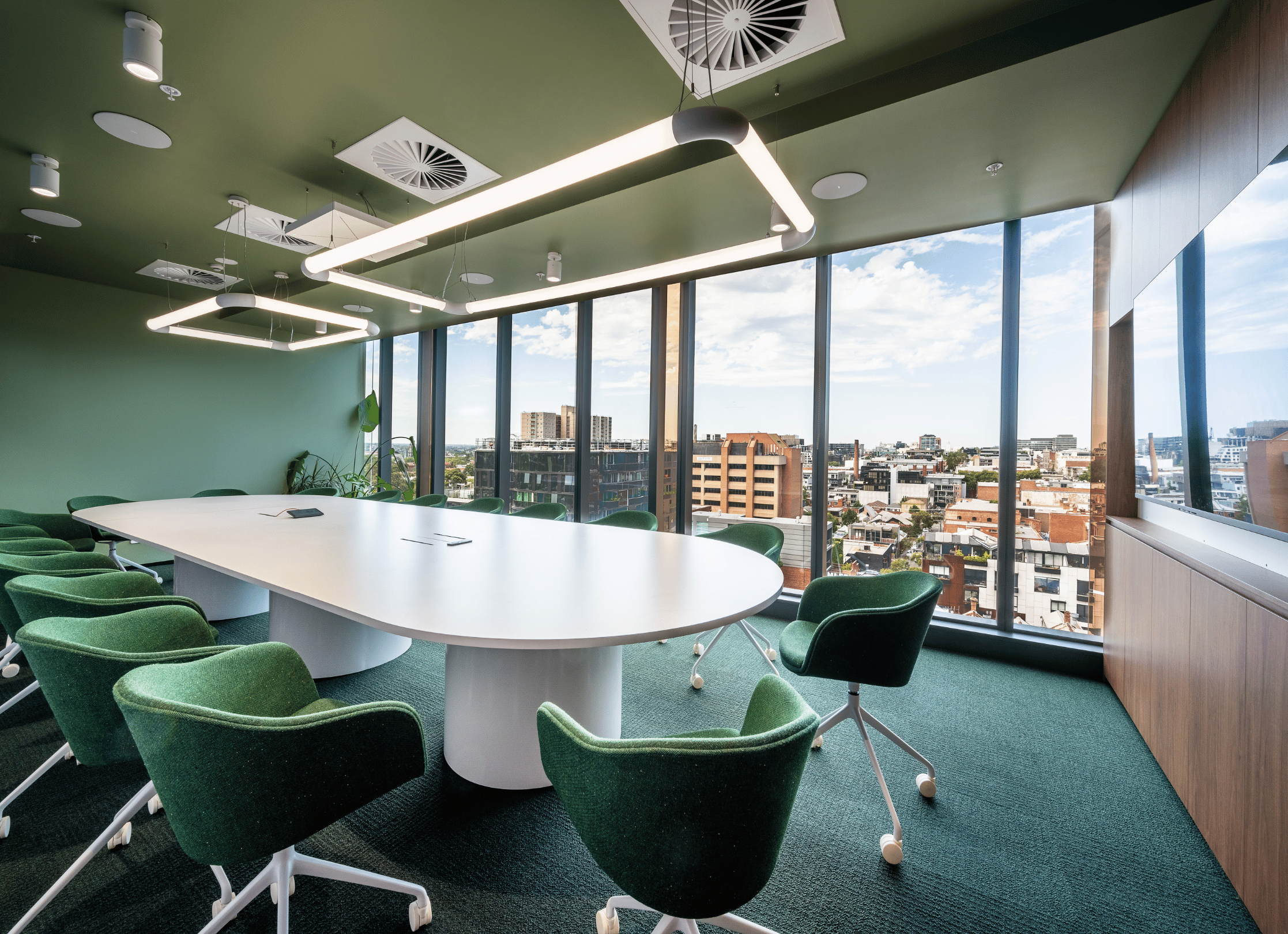 A large Microsoft Teams Boardroom equipped with a Logitech system and Sennheiser TeamConnect ceiling mics