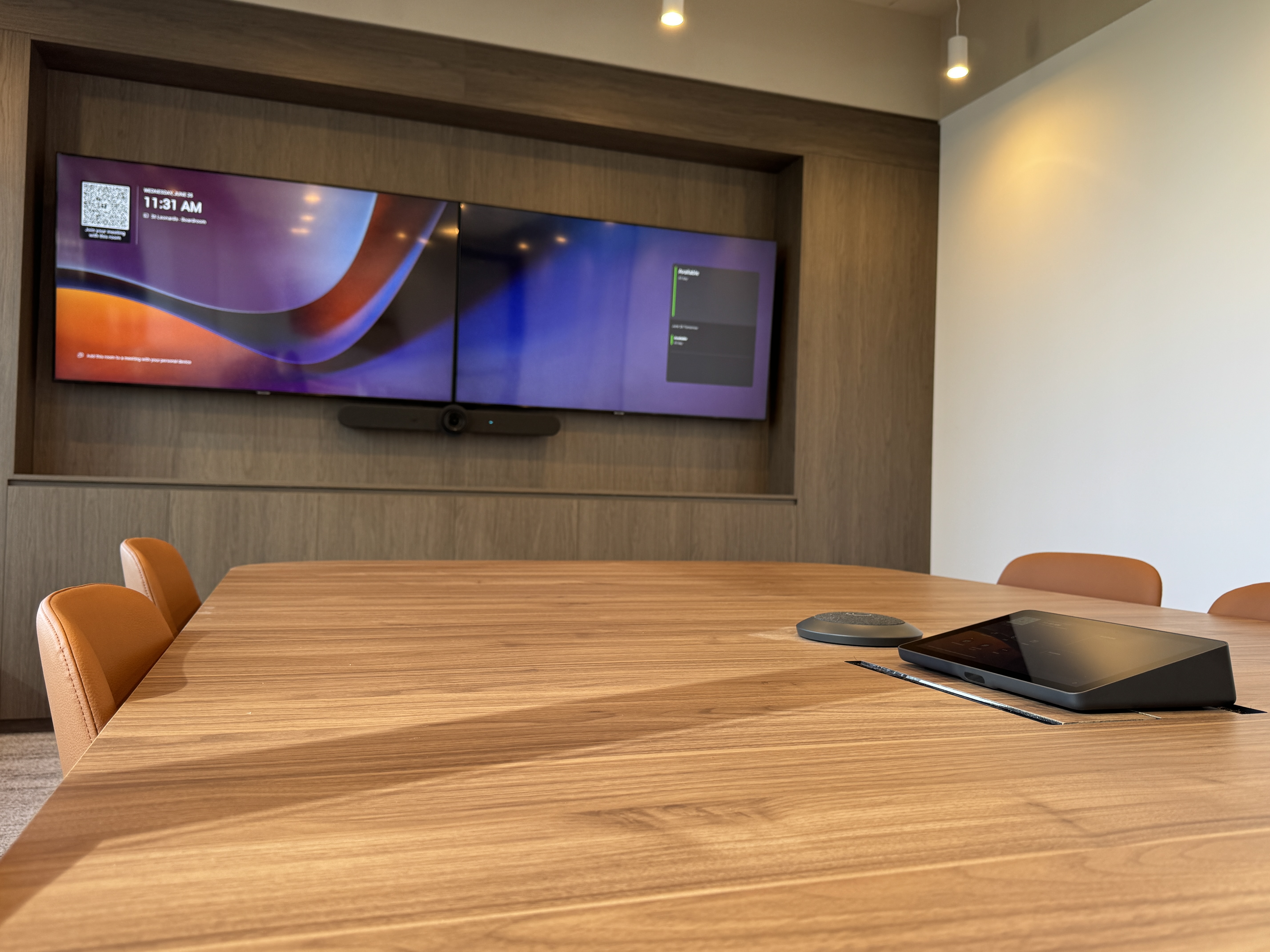 Large Microsoft Teams boardroom equipped with Logitech Rally Bar, Logitech Tap IP, Logitech Mic Pod, and Logitech Extend