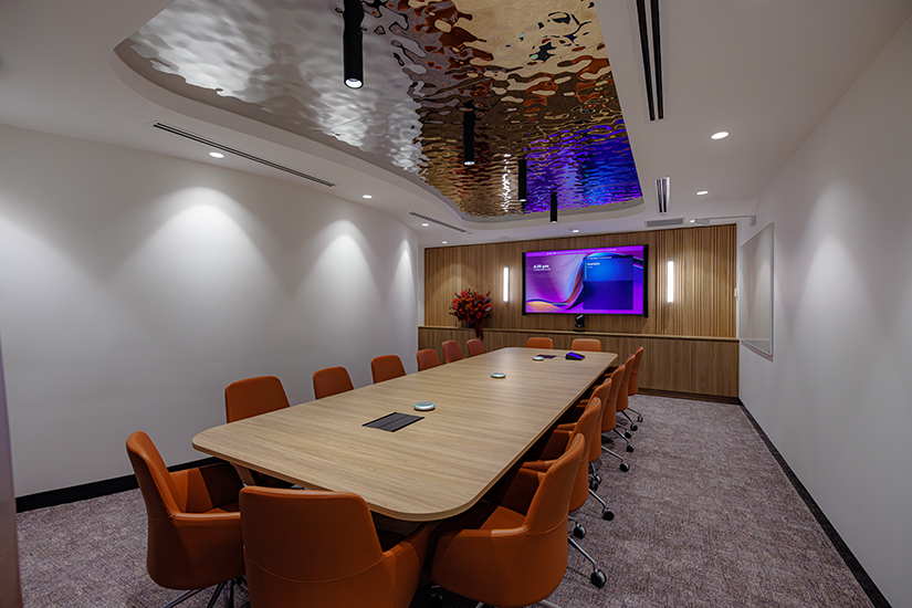 Large Microsoft Teams boardroom with Logitech Rally camera, Logitech Tap touch controller, and Logitech microphones