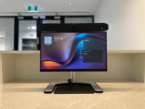 Microsoft Teams Room Express equipped with HP Poly X52 video bar, HP 27" monitor, HP dock (back of monitor)
