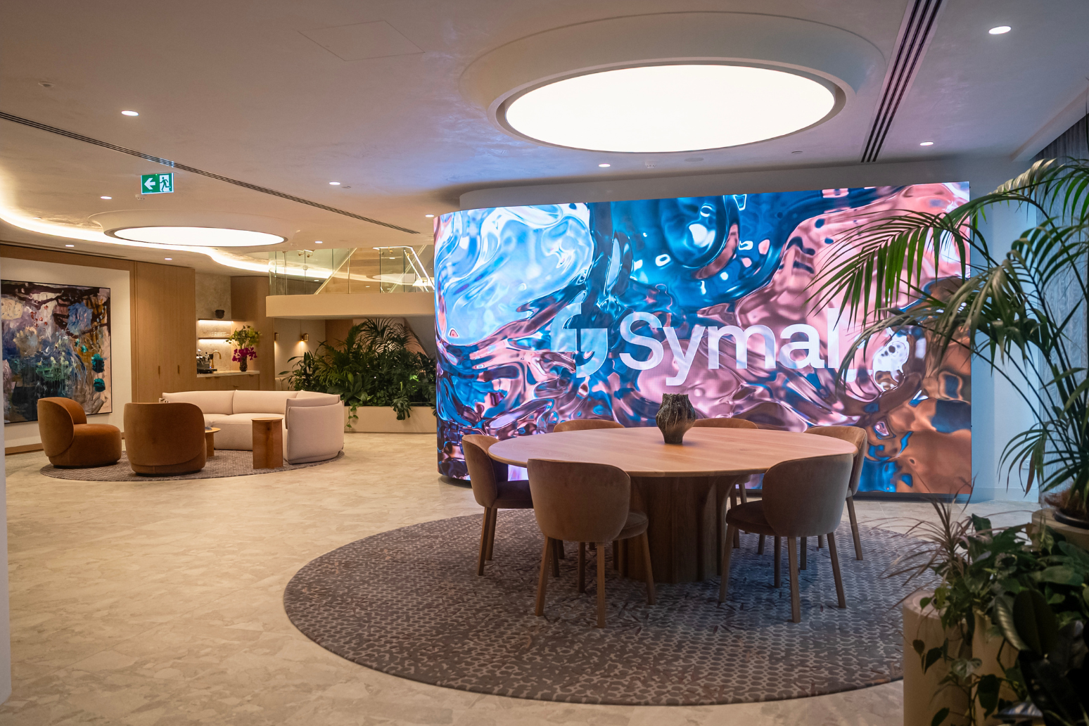 Custom Absen curved 8.25m x 2.5m K1.8 V3 LED wall at client's reception area. Inavate APAC 2026 Corporate Project of the Year Finalist with Symal.